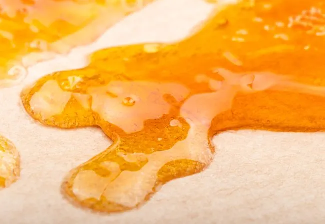 a golden-yellow liquid like substance on top of parchment paper