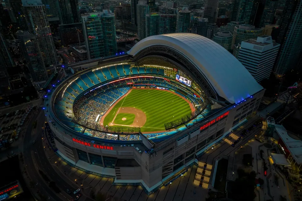 Birds’ eye view of the Rogers Centre dome open during a Blue Jays baseball game in the early evening.